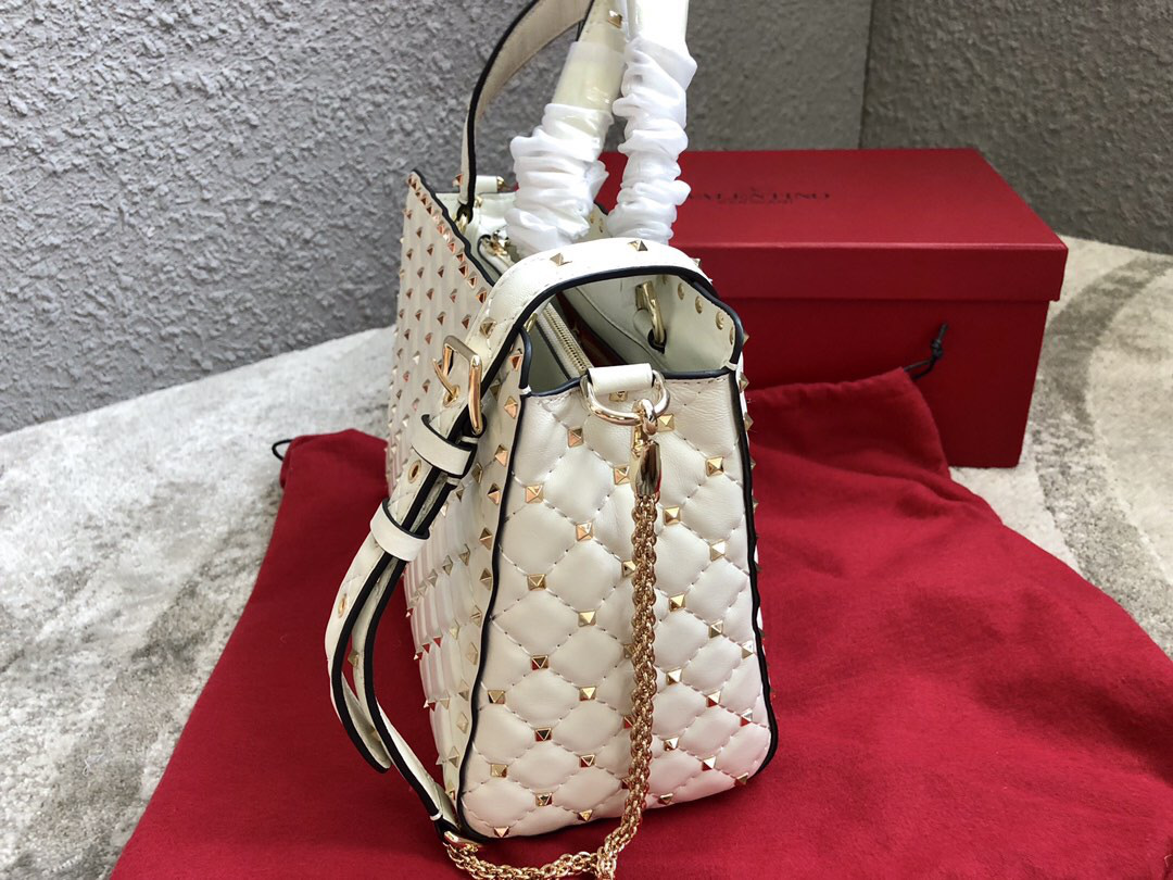 Va1e*ntin0 Garavani Rockstud Spike Lambskin Handbag in white