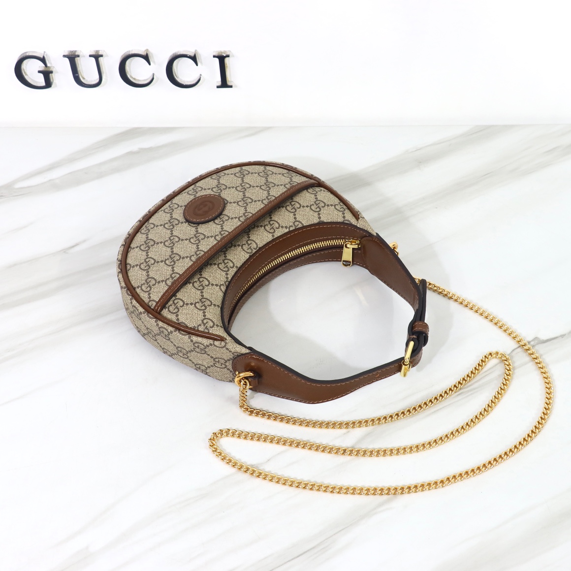 Bagsaaa Gvc*1 GG Half Moon Shaped Mini Bag in Beige and ebony GG Svp*me canvas - 22 x 12.5 x 5cm