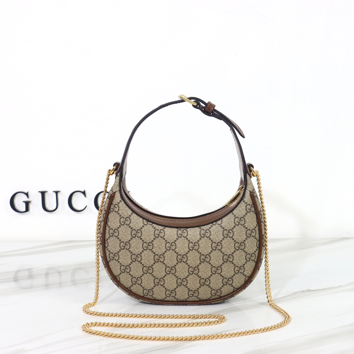 Bagsaaa Gvc*1 GG Half Moon Shaped Mini Bag in Beige and ebony GG Svp*me canvas - 22 x 12.5 x 5cm