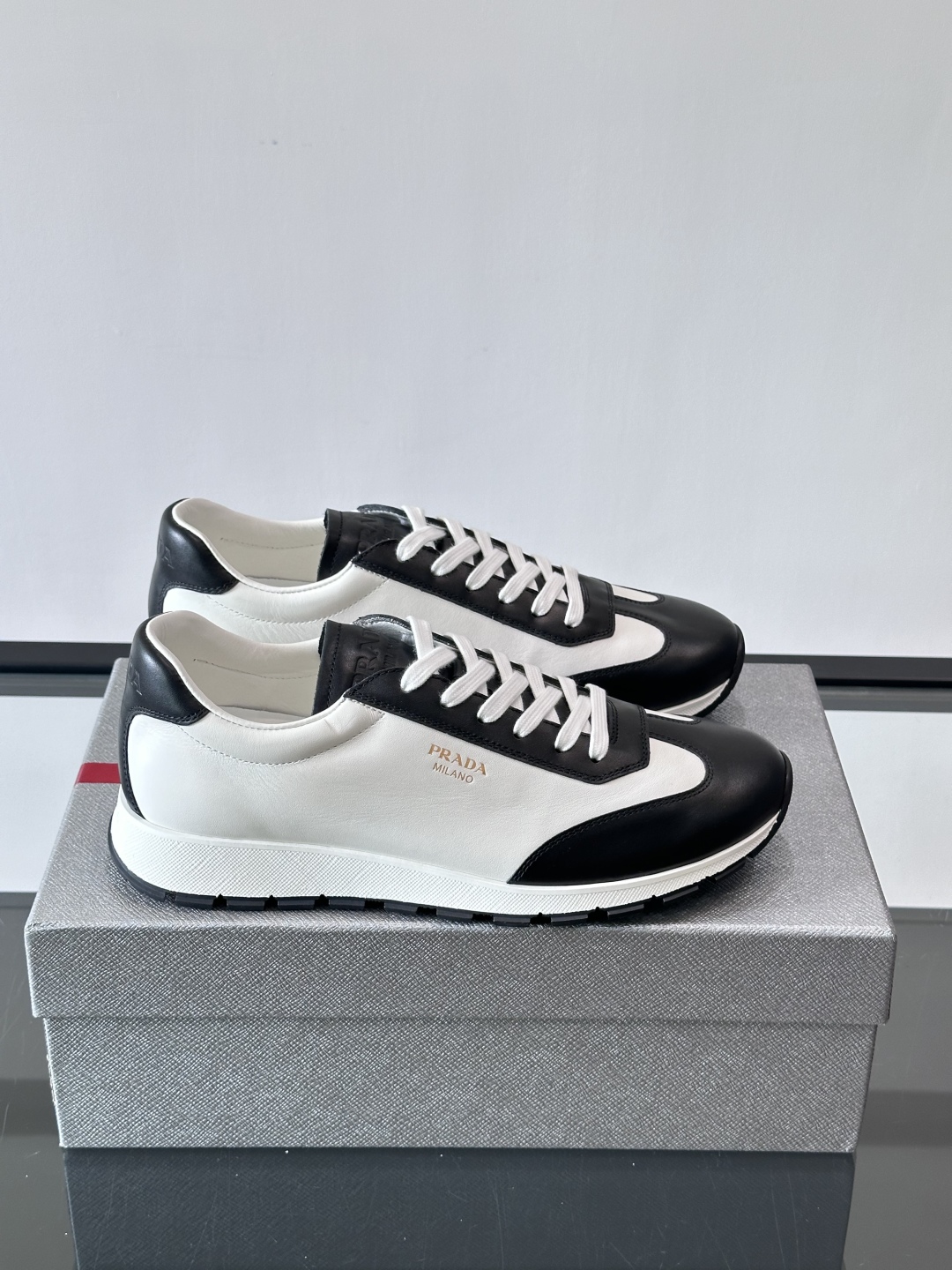 Bagsaaa Pra*a Downtown low-top sneakers in white and black