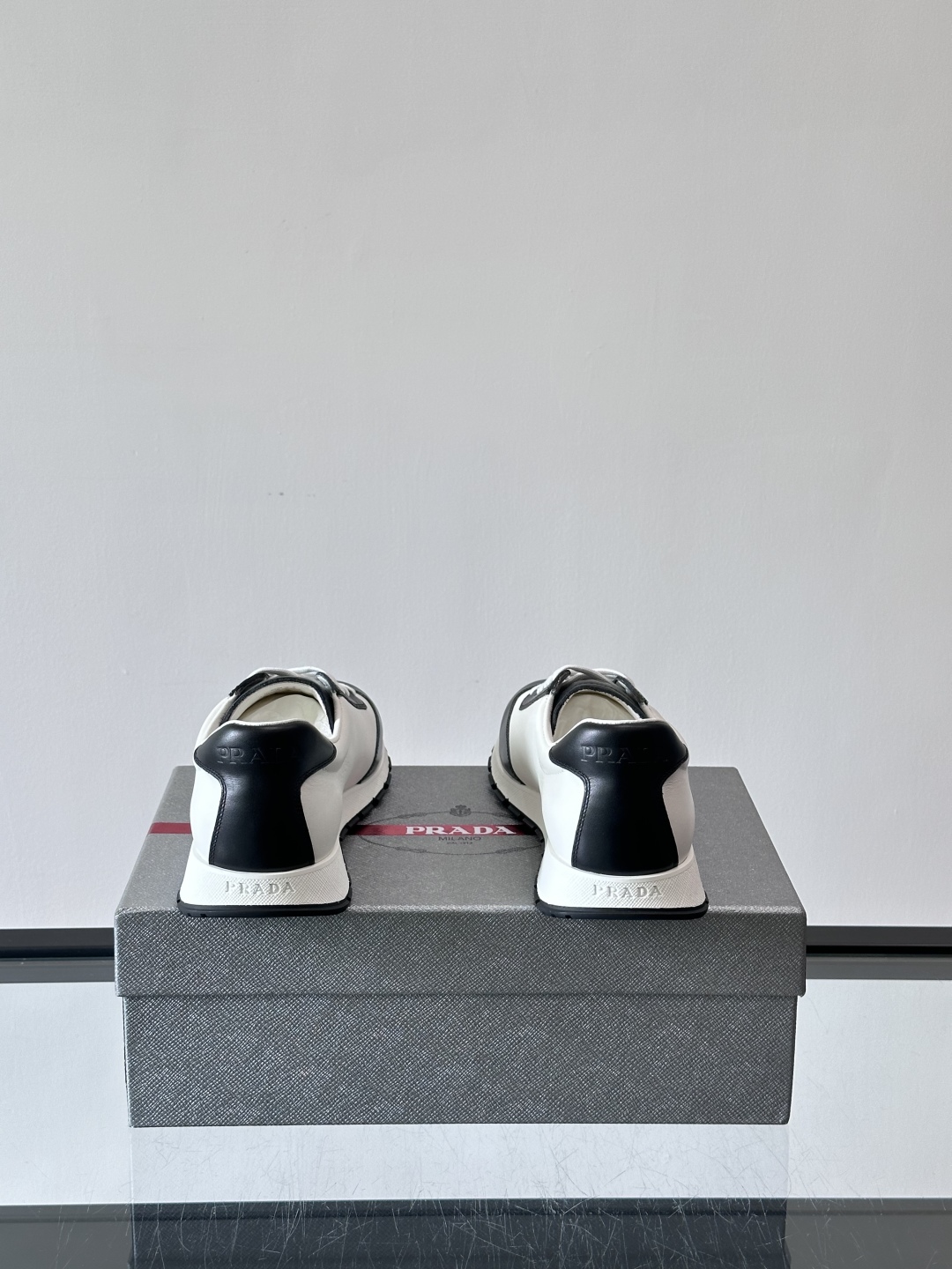 Bagsaaa Pra*a Downtown low-top sneakers in white and black