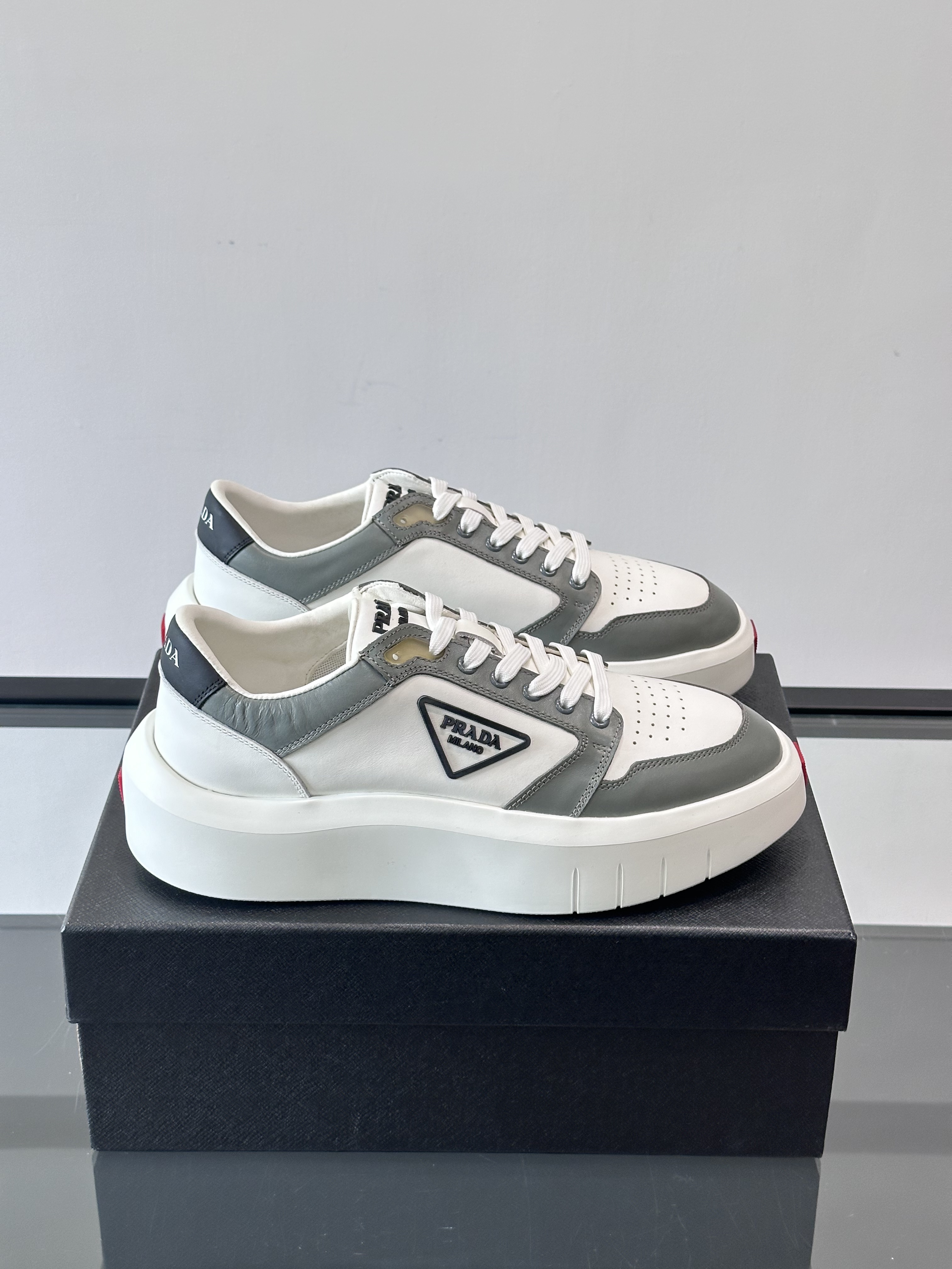 Bagsaaa Pra*a Downtown leather sneakers in a white and gray colorway