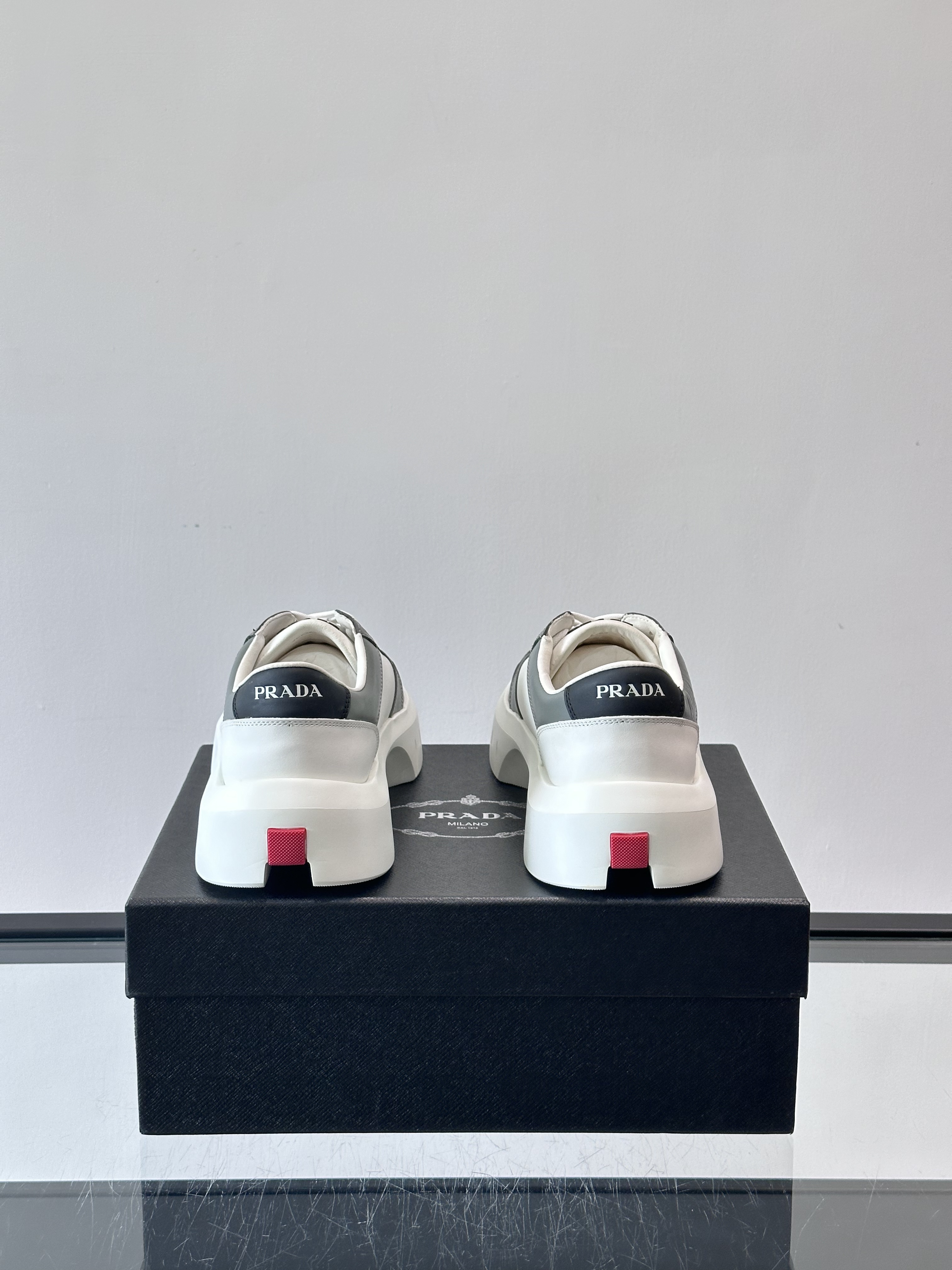 Bagsaaa Pra*a Downtown leather sneakers in a white and gray colorway