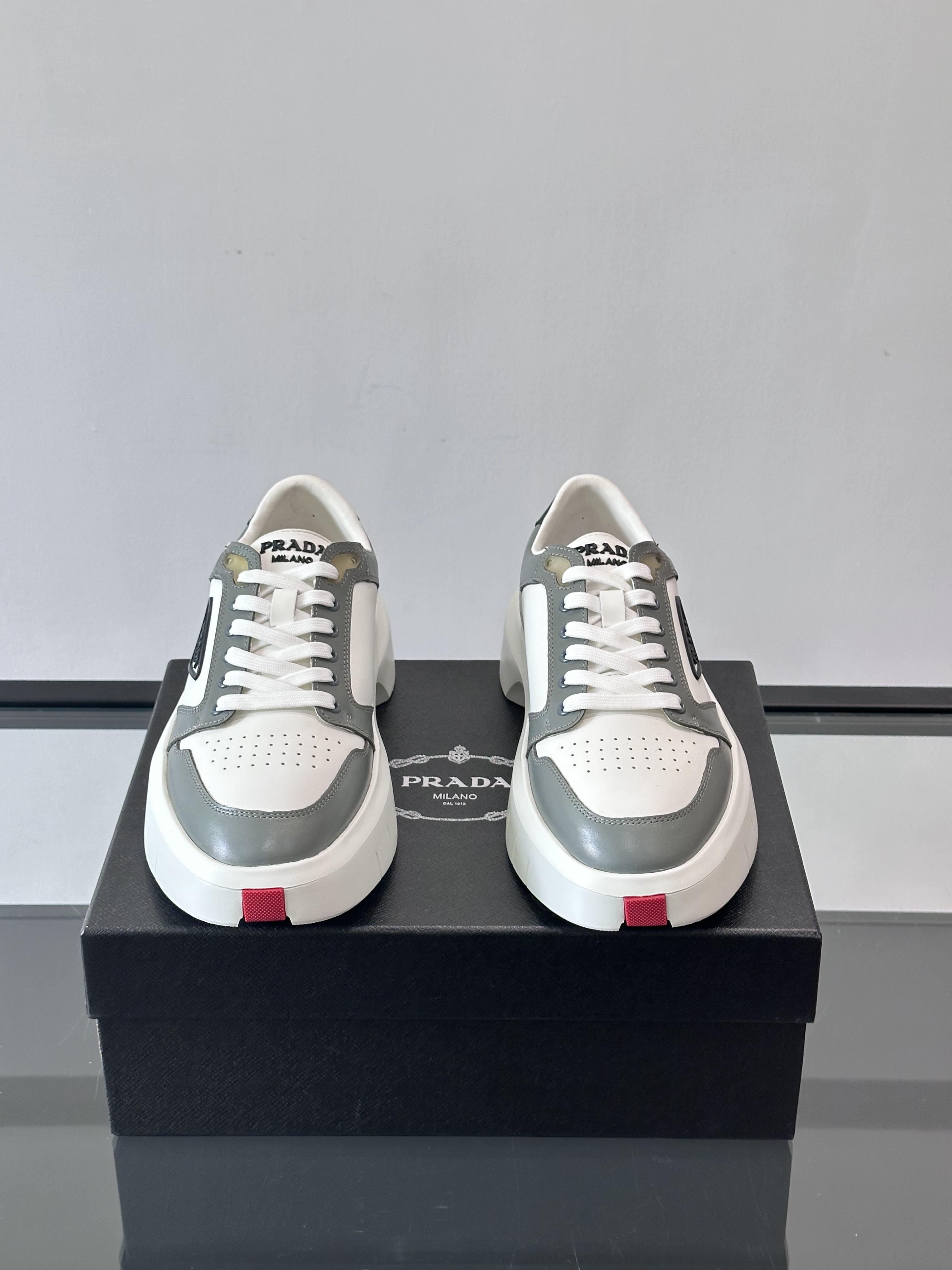 Bagsaaa Pra*a Downtown leather sneakers in a white and gray colorway