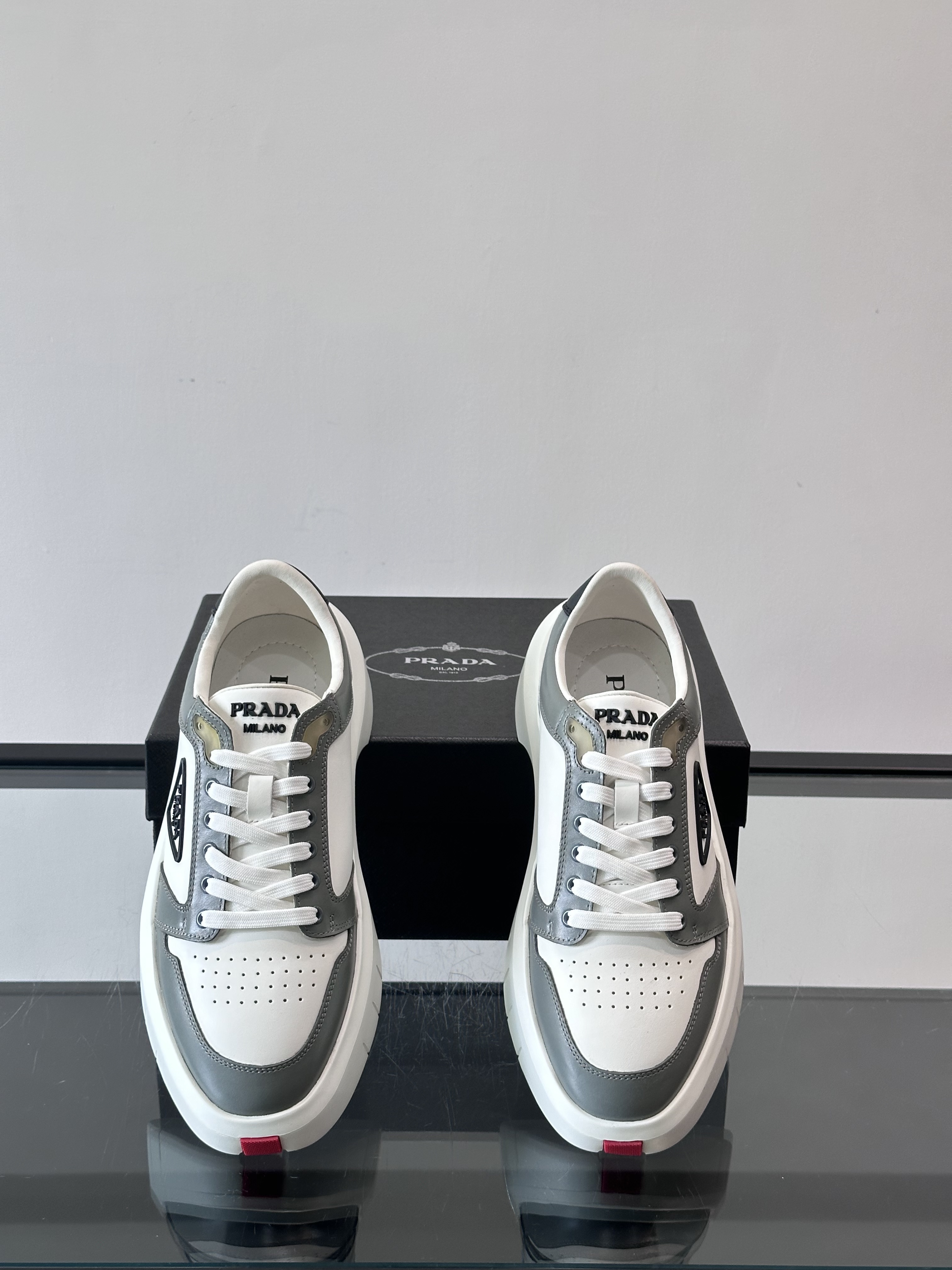 Bagsaaa Pra*a Downtown leather sneakers in a white and gray colorway
