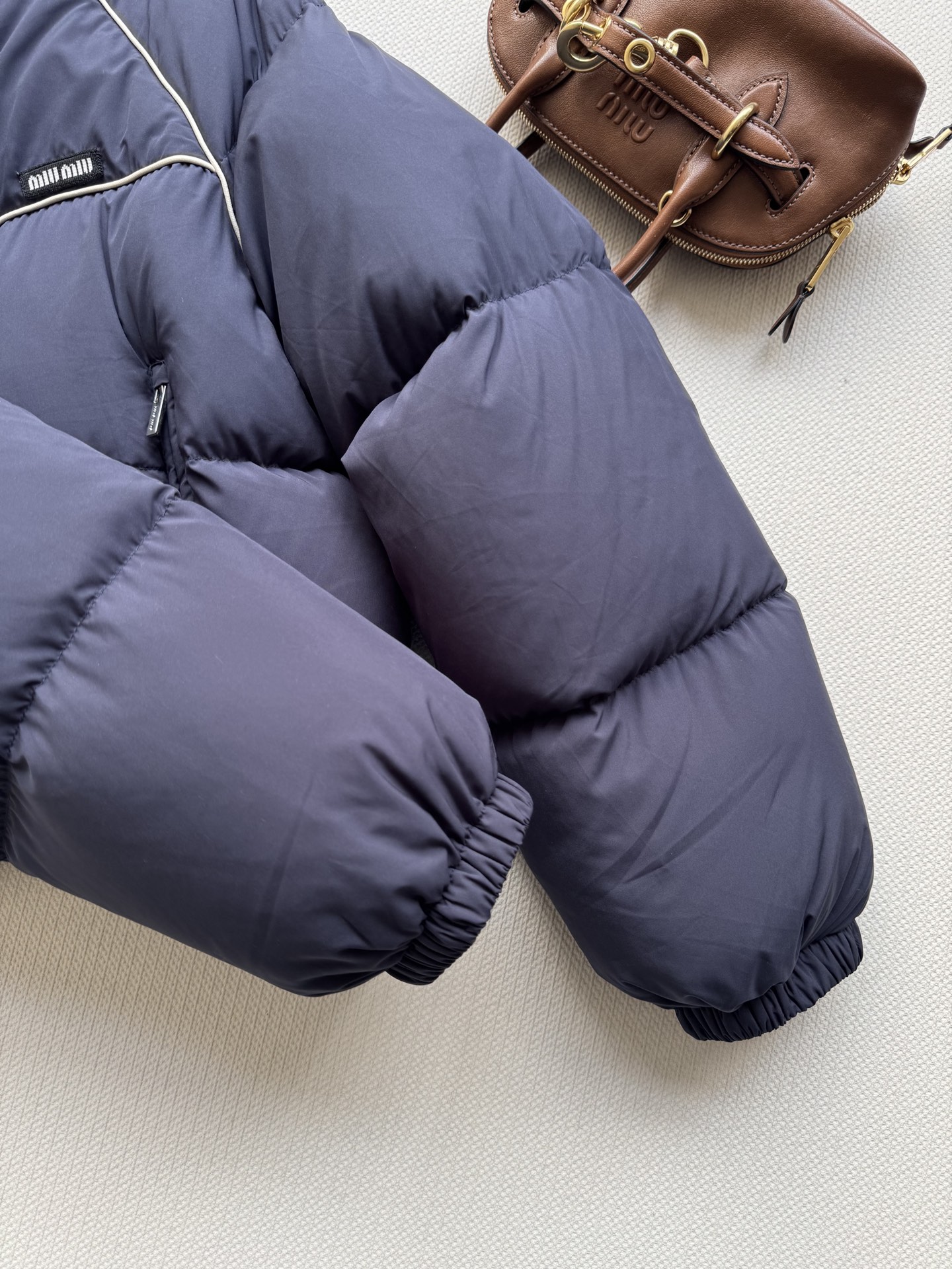 Bagsaaa Miu Miu down jacket with high collar and a cropped length navy blue