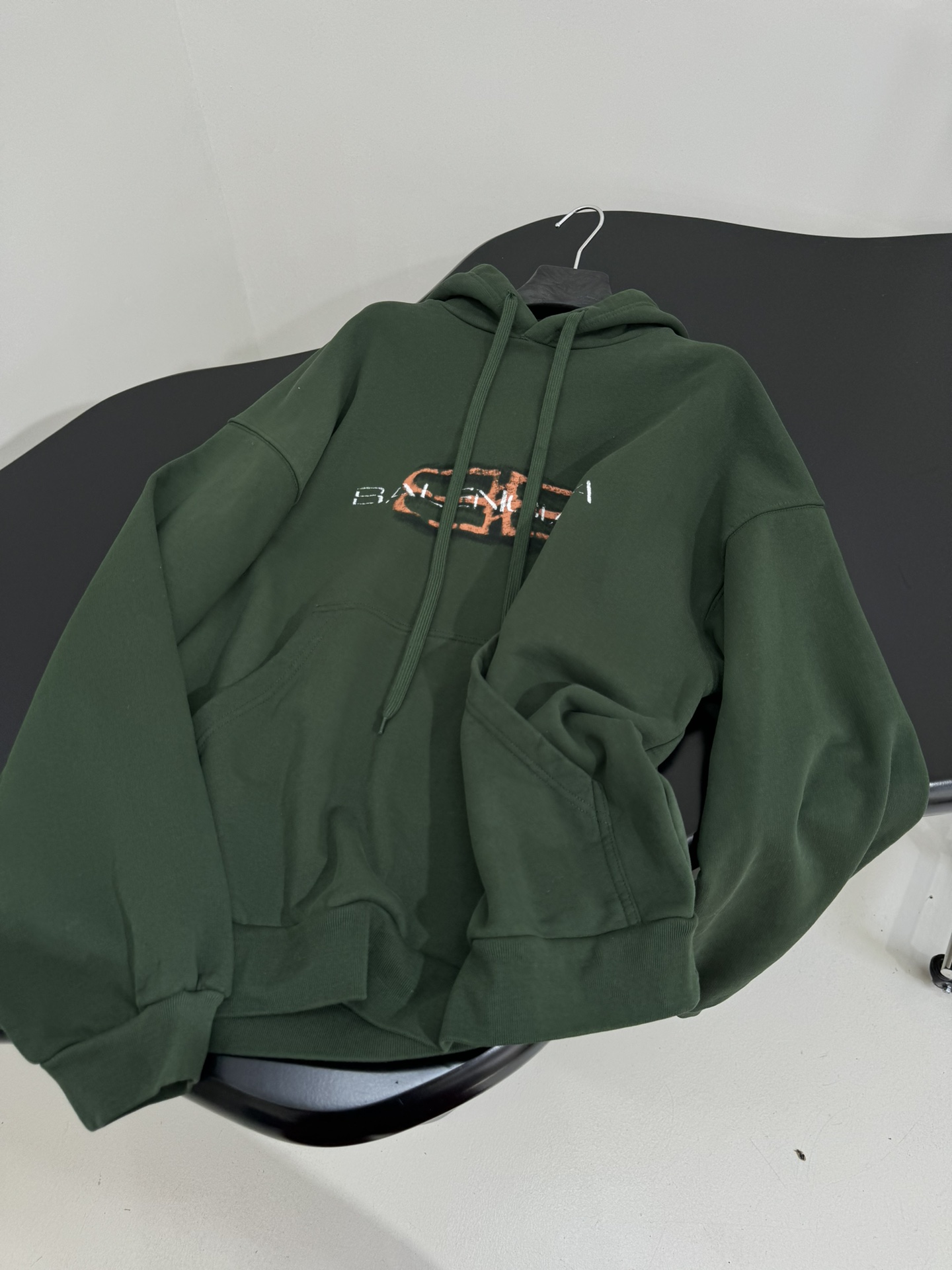 Bagsaaa Ba1en*iaga green hoodie with a shaded logo effect