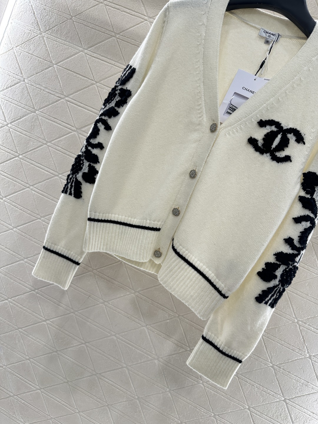 Bagsaaa Ch**el cardigan in white with black floral appliqués