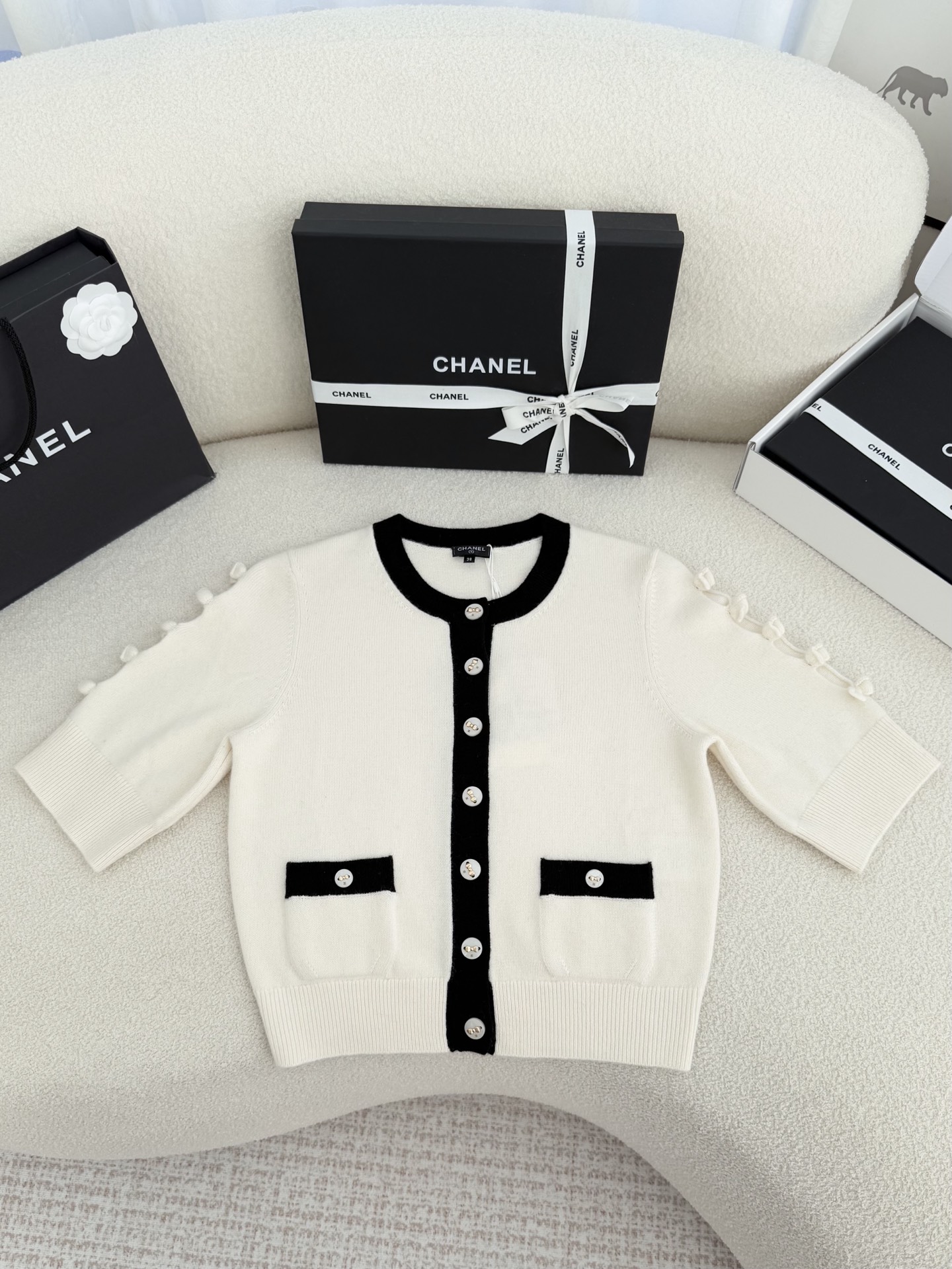 Bagsaaa Ch**el cardigan in a white knit with black trim and pearl buttons