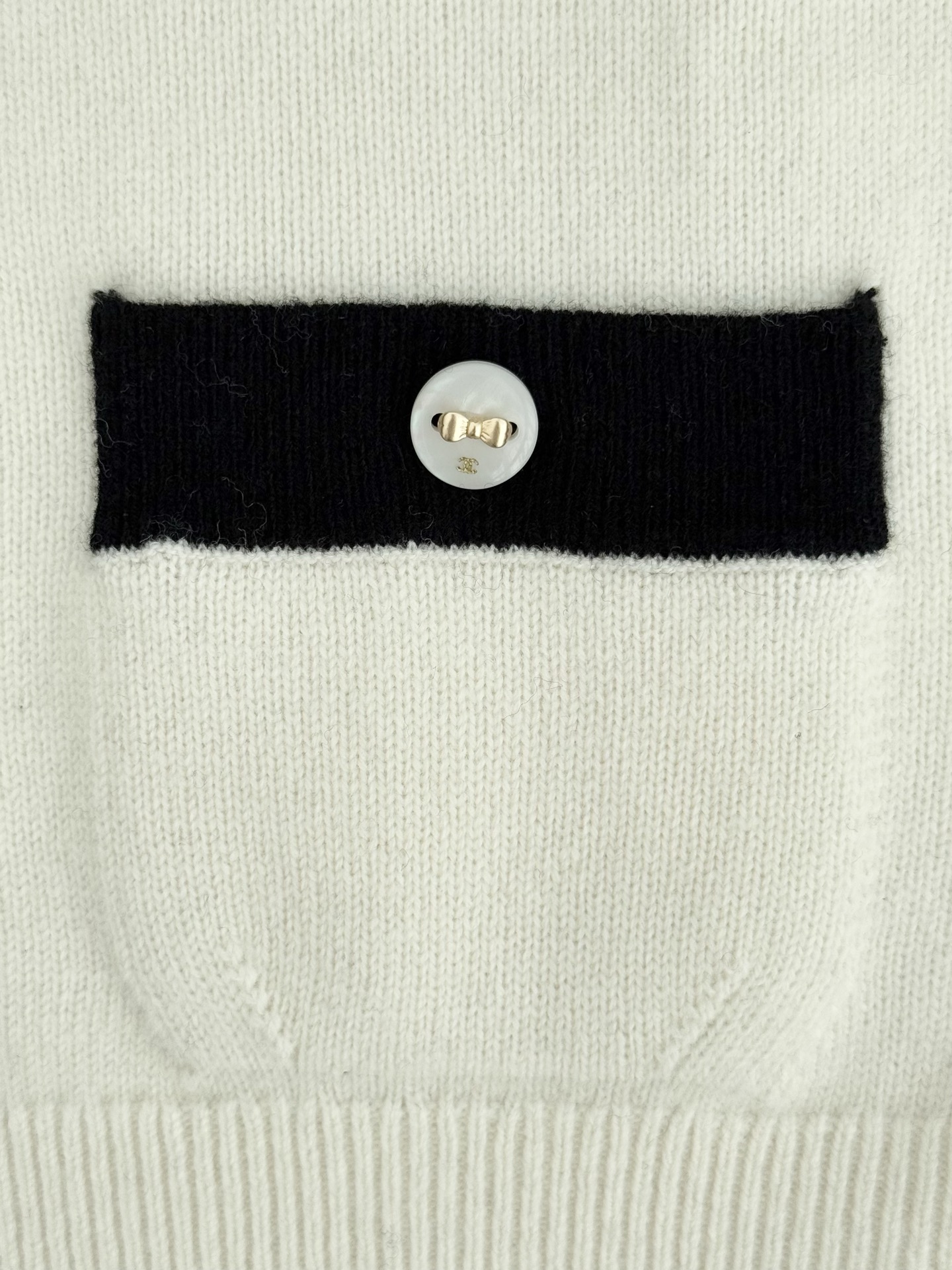 Bagsaaa Ch**el cardigan in a white knit with black trim and pearl buttons