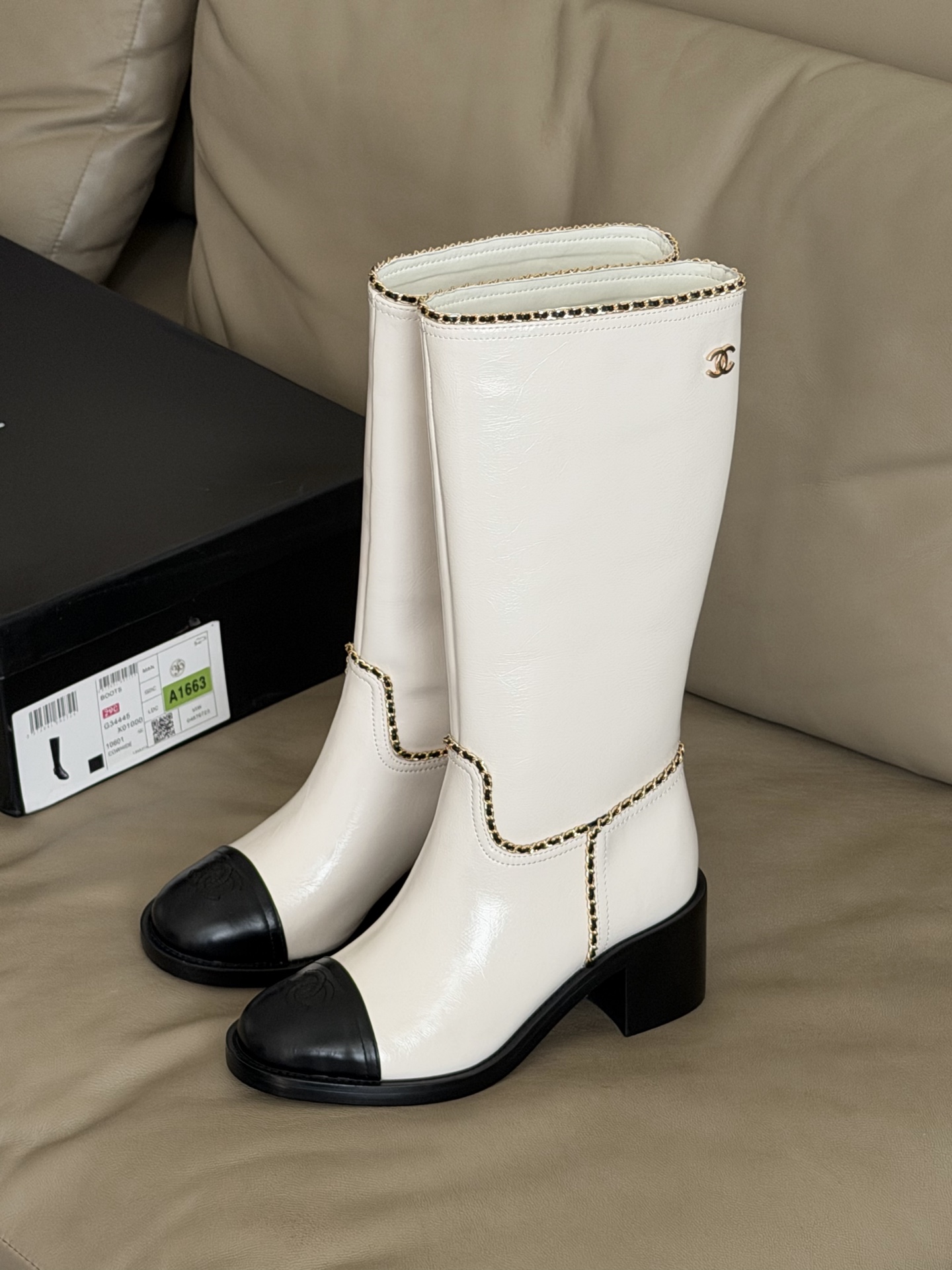 Bagsaaa Ch**el mid-calf boots in white patent leather with black cap toes