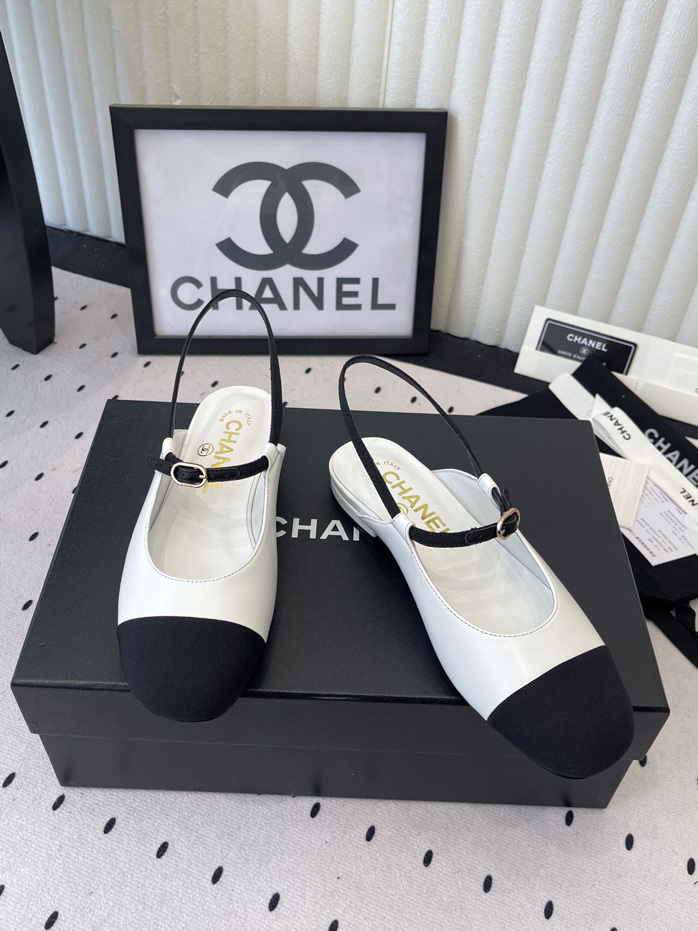 Bagsaaa Ch**el leather Mary Jane flats in white and black with an ankle strap