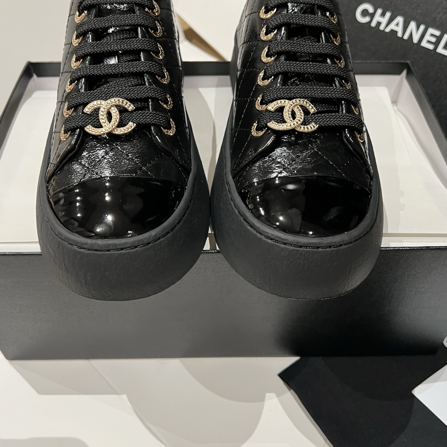 Bagsaaa black patent leather Ch**el low-top sneakers with gold-tone hardware