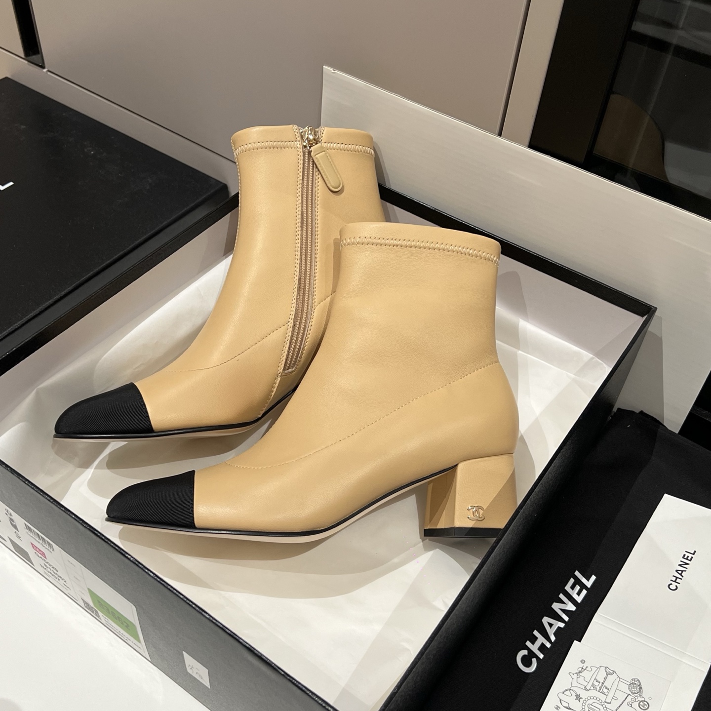 Bagsaaa Ch**el beige and black leather cap-toe ankle boots with zipper