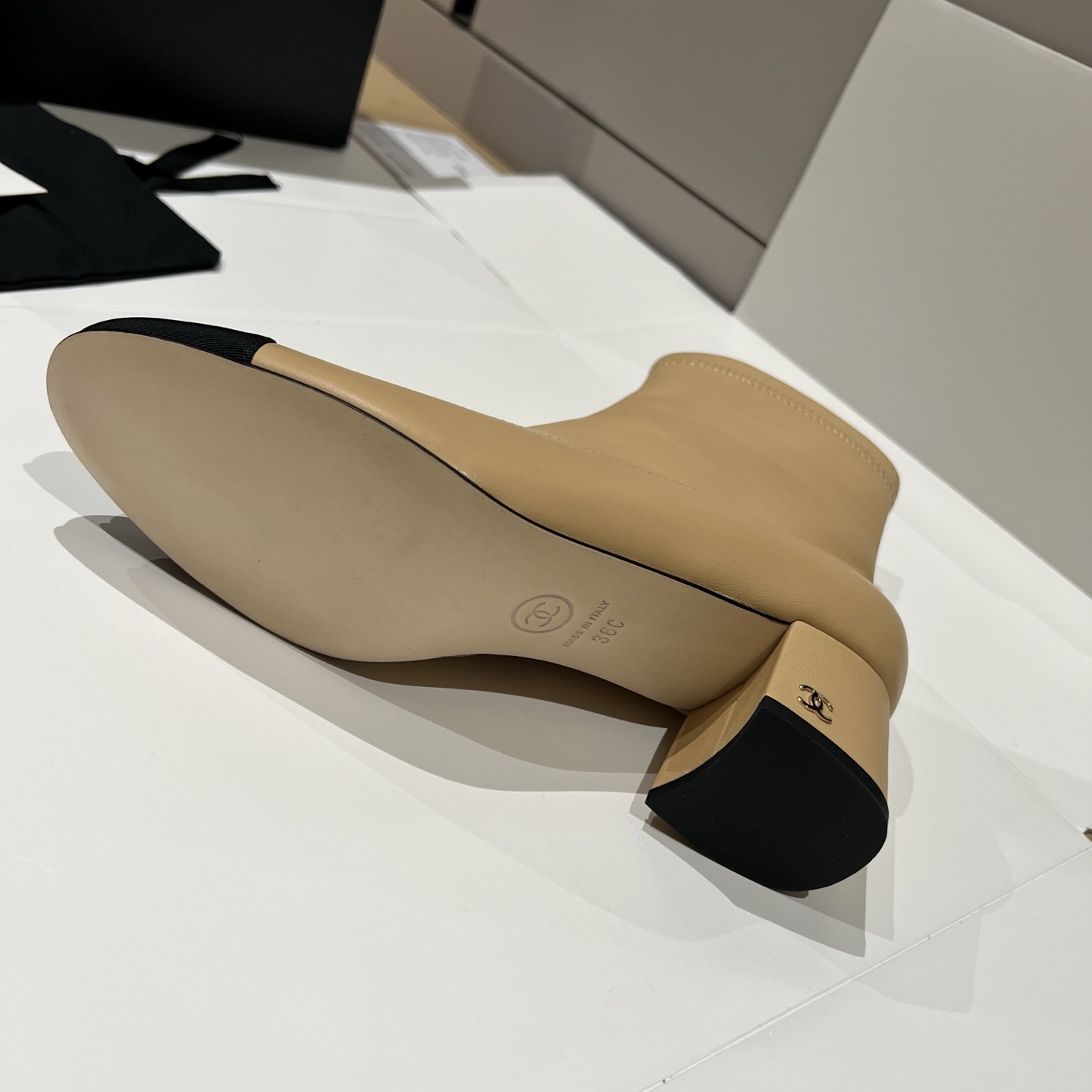 Bagsaaa Ch**el beige and black leather cap-toe ankle boots with zipper