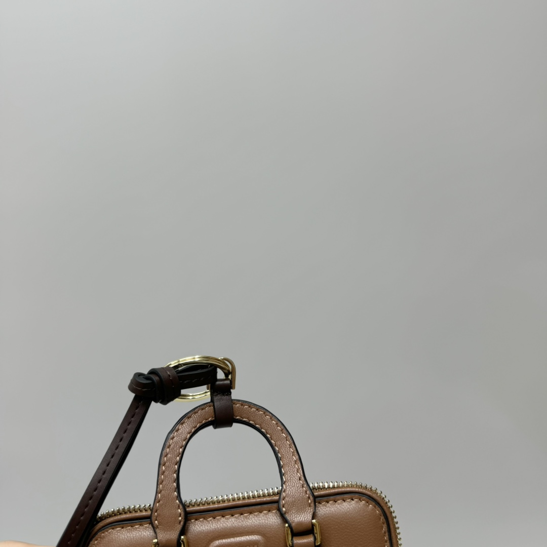 Bagsaaa Miu Miu Trick Arcadie leather keychain charm in a brown