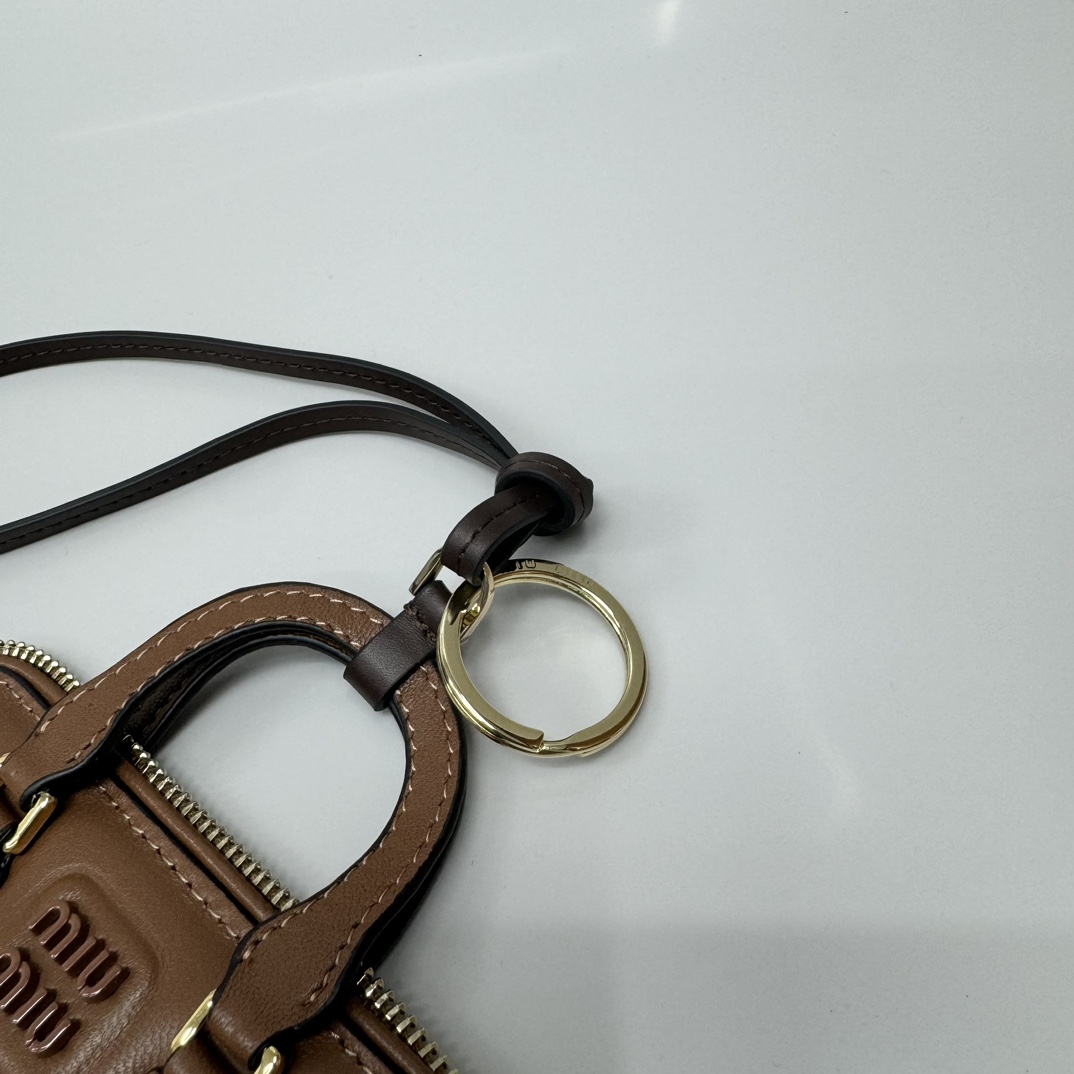 Bagsaaa Miu Miu Trick Arcadie leather keychain charm in a brown