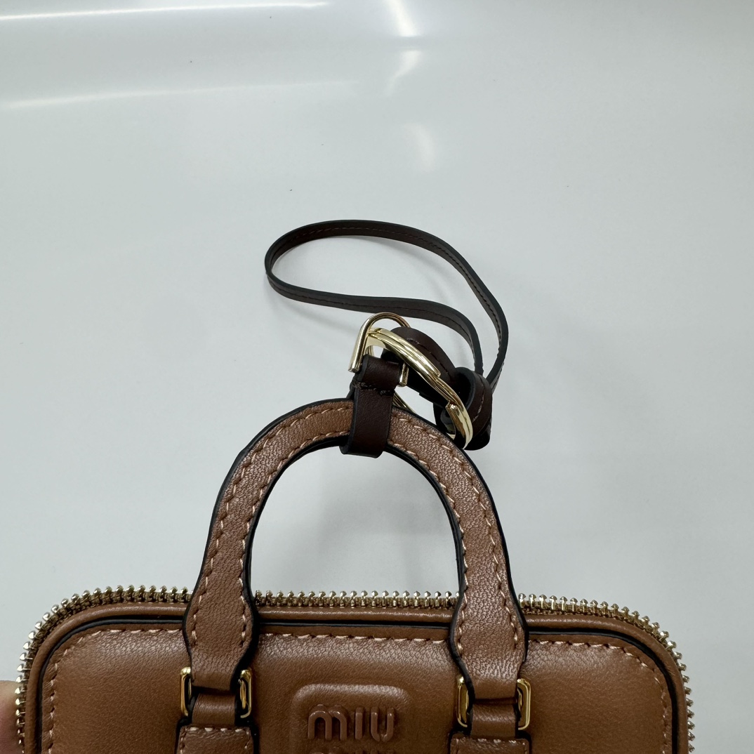 Bagsaaa Miu Miu Trick Arcadie leather keychain charm in a brown